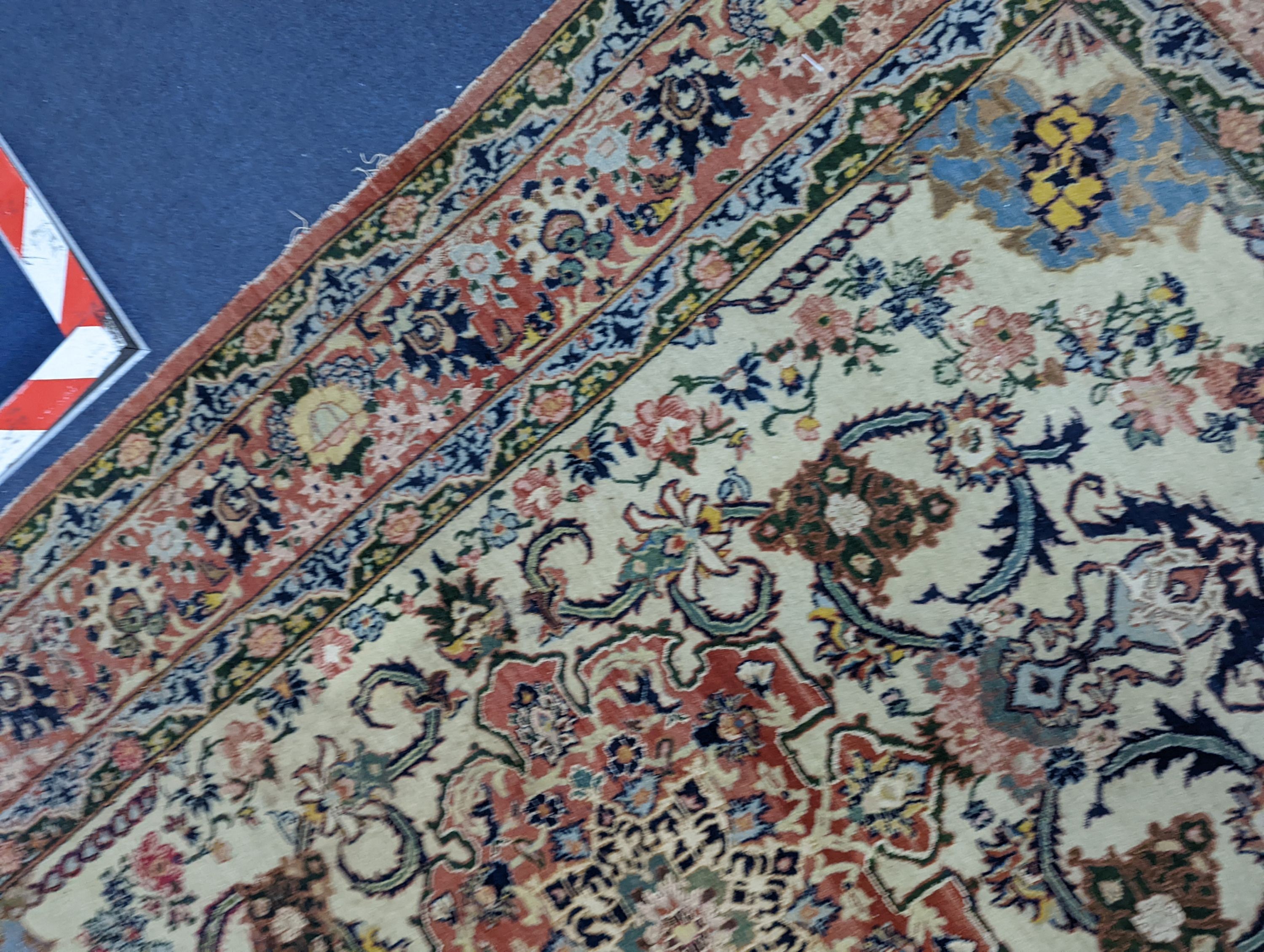 A part silk Isfahan cream rug with central floral scroll medallion, 196 x 140cm